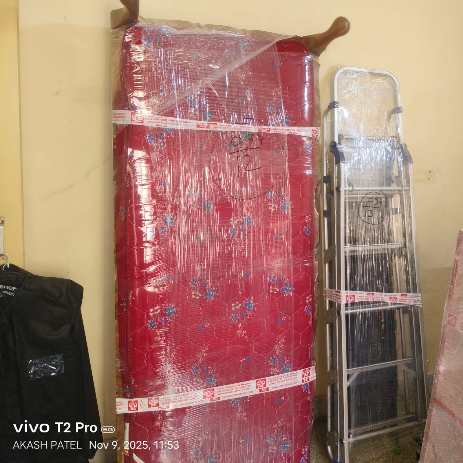 Professional packers and movers in Bangalore packing a diwan with bubble wrap and protective materials for safe relocation